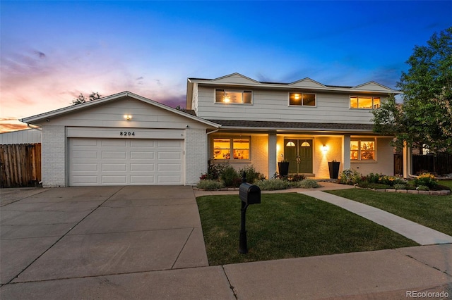 view of front facade with a garage and a yard