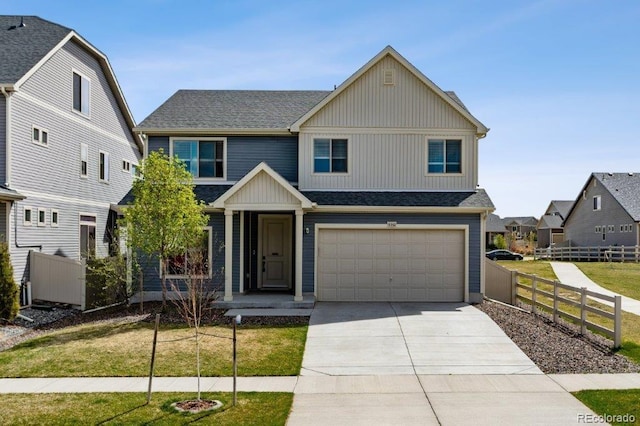 view of front of house featuring driveway, a shingled roof, a garage, and fence