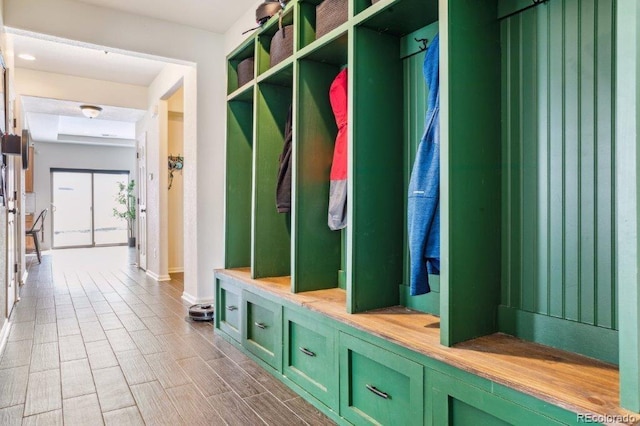 mudroom featuring wood finish floors and baseboards