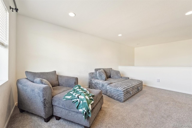 sitting room with carpet flooring, recessed lighting, and baseboards