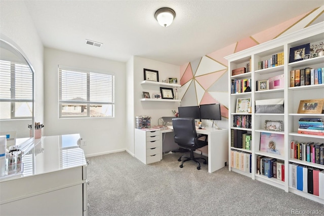 carpeted home office featuring visible vents and baseboards