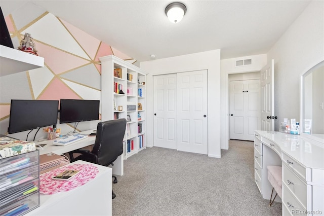 office space featuring light colored carpet, visible vents, and arched walkways