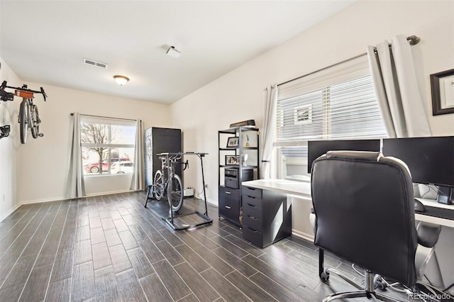 office area featuring visible vents, baseboards, and wood finish floors