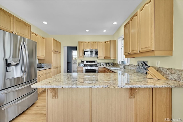 41479 Countryside Cir, Parker, CO 80138 - kitchen featuring appliances with stainless steel finishes, light brown cabinets, a peninsula, plenty of natural light, and recessed lighting