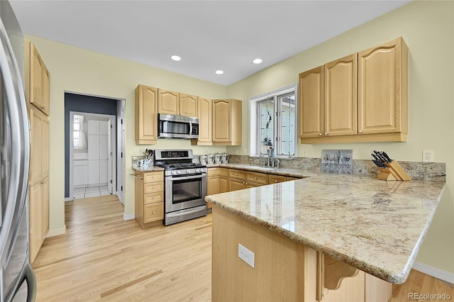 41479 Countryside Cir, Parker, CO 80138 - kitchen with stainless steel appliances, light brown cabinetry, a peninsula, light wood-style flooring, and recessed lighting