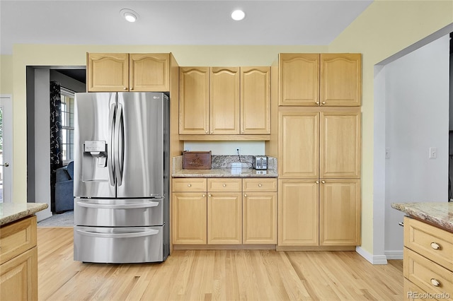 41479 Countryside Cir, Parker, CO 80138 - kitchen featuring stainless steel fridge with ice dispenser, light brown cabinetry, light wood finished floors, light stone countertops, and recessed lighting
