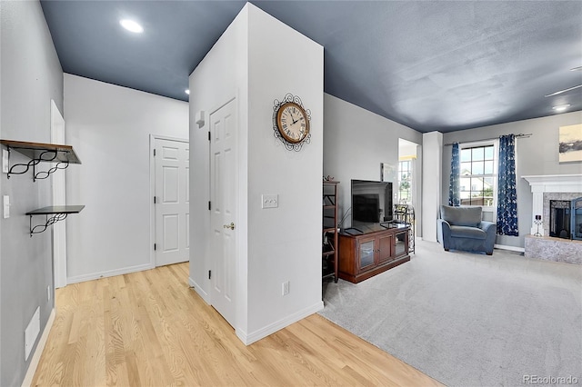 41479 Countryside Cir, Parker, CO 80138 - living area featuring a fireplace with raised hearth and wood finished floors