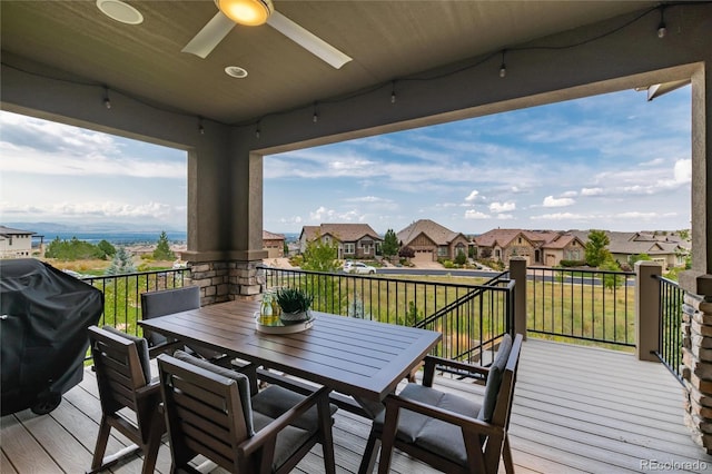 wooden deck featuring grilling area and ceiling fan