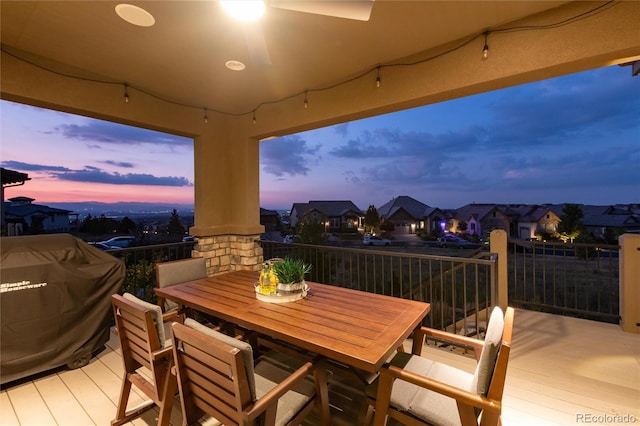 deck at dusk featuring area for grilling