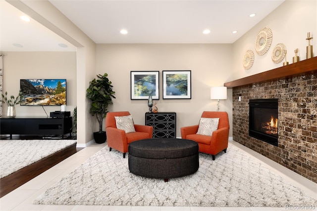 tiled living room featuring a brick fireplace