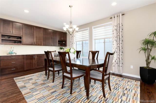 dining space featuring a notable chandelier and dark hardwood / wood-style floors