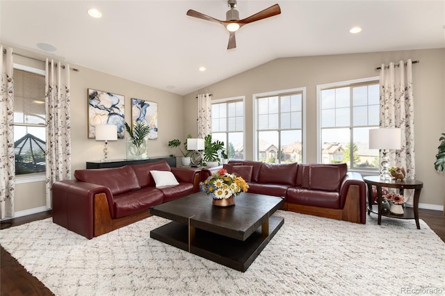 living room with dark wood-type flooring, vaulted ceiling, and ceiling fan