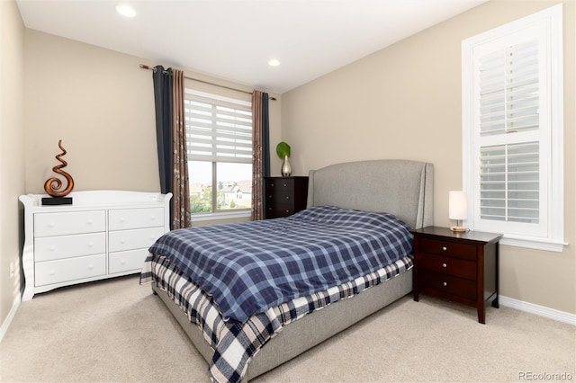 bedroom featuring light colored carpet