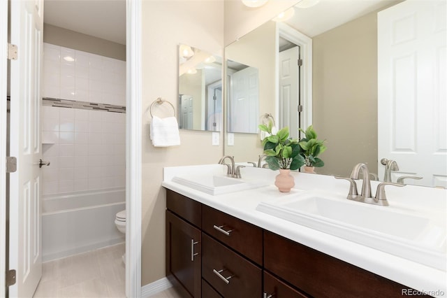 full bathroom featuring vanity, toilet, and tiled shower / bath