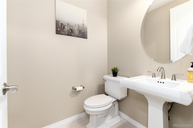 bathroom with tile patterned flooring and toilet