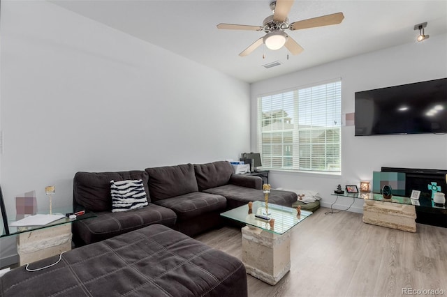 9185 Wilde Ln Unit 101, Parker, CO 80134 - living room featuring wood finished floors, ceiling fan, and baseboards