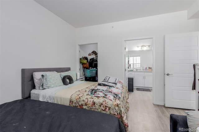 9185 Wilde Ln Unit 101, Parker, CO 80134 - bedroom with light wood-style floors and connected bathroom