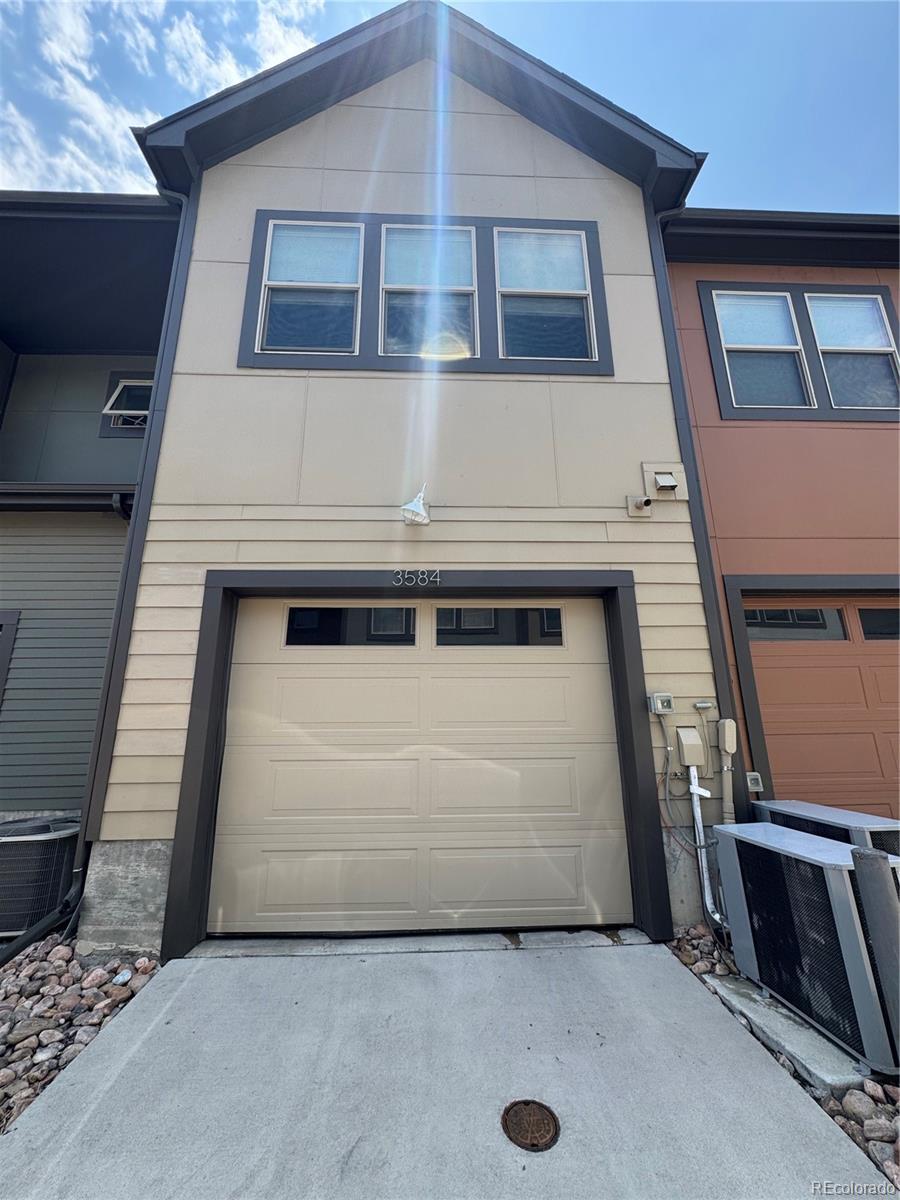 3584 Central Park Blvd, Denver, CO 80238 - view of front of house featuring a garage and concrete driveway