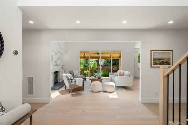 5944 E Irwin Pl, Centennial, CO 80112 - living area featuring light wood-type flooring, a premium fireplace, and recessed lighting