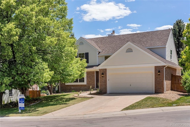 5944 E Irwin Pl, Centennial, CO 80112 - view of front facade featuring brick siding, a garage, concrete driveway, and a shingled roof