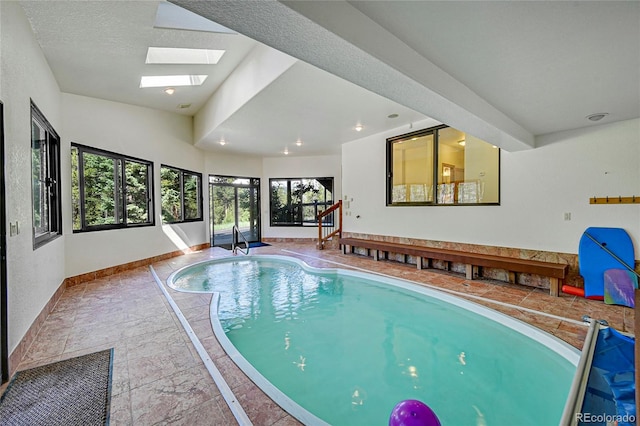 view of swimming pool with a skylight