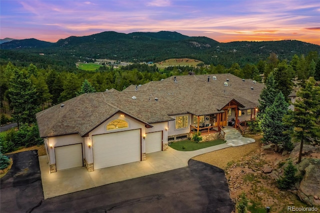 view of front of home with a mountain view and a garage