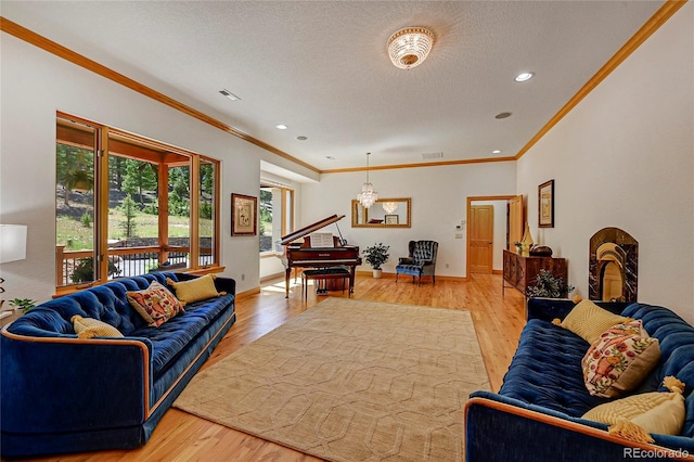 living room with an inviting chandelier, ornamental molding, and light wood-type flooring