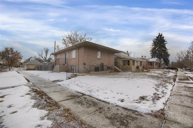 snow covered property featuring central air condition unit