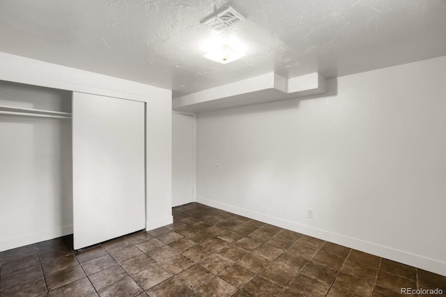 unfurnished bedroom featuring a closet and a textured ceiling