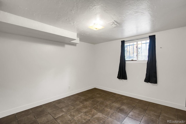 unfurnished room featuring a textured ceiling