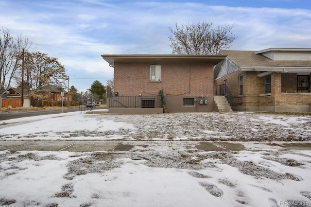 view of snow covered rear of property