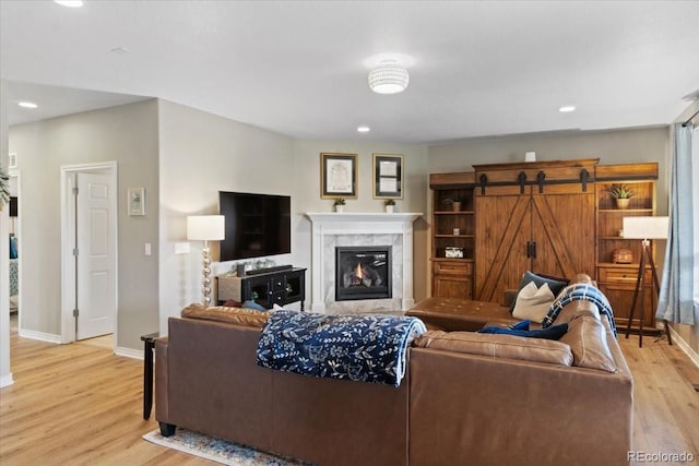 17102 W 85th Pl, Arvada, CO 80007 - living room with light wood-style floors, baseboards, a tile fireplace, and recessed lighting