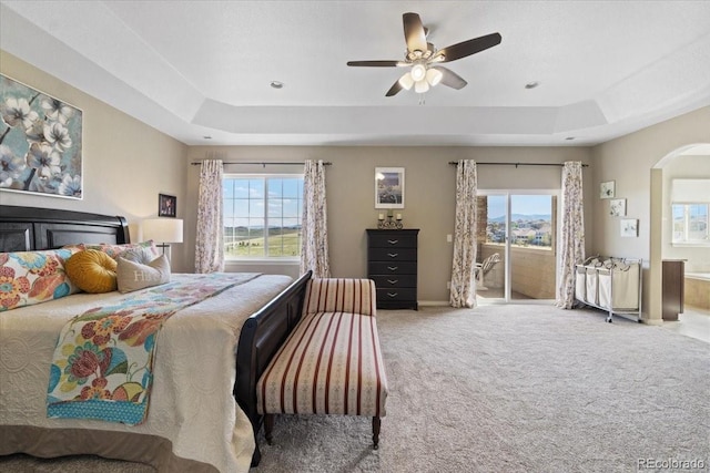 17102 W 85th Pl, Arvada, CO 80007 - bedroom featuring a raised ceiling, access to exterior, and multiple windows