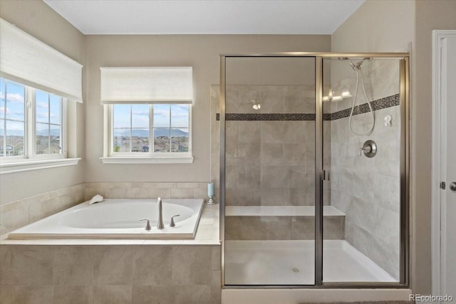 17102 W 85th Pl, Arvada, CO 80007 - bathroom with plenty of natural light, a bath, and a stall shower