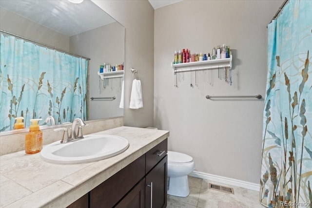 17102 W 85th Pl, Arvada, CO 80007 - full bathroom with toilet, vanity, baseboards, and tile patterned flooring