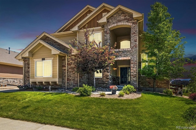 17102 W 85th Pl, Arvada, CO 80007 - craftsman-style home featuring stone siding, a front yard, and board and batten siding