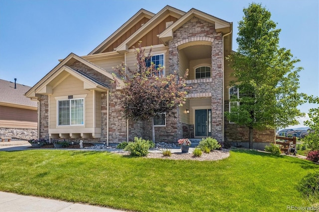 17102 W 85th Pl, Arvada, CO 80007 - view of front of property featuring stone siding, a front yard, and board and batten siding