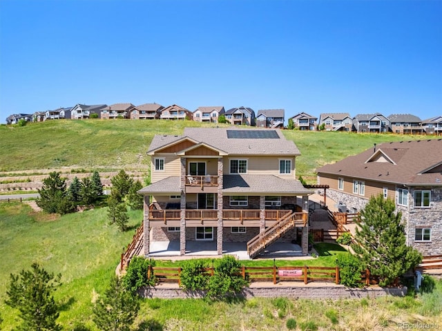 17102 W 85th Pl, Arvada, CO 80007 - back of house featuring a fenced backyard, a residential view, a patio, a balcony, and a deck