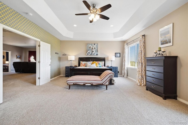 17102 W 85th Pl, Arvada, CO 80007 - carpeted bedroom with wallpapered walls, an accent wall, a tray ceiling, ceiling fan, and recessed lighting