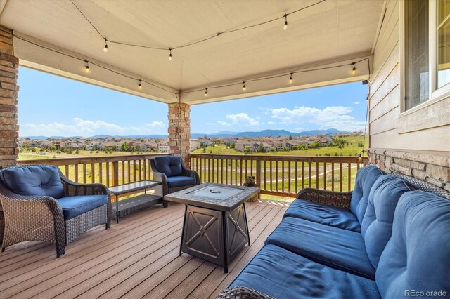 17102 W 85th Pl, Arvada, CO 80007 - wooden terrace featuring a mountain view and an outdoor living space with a fire pit