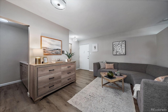 living area featuring baseboards and wood finished floors