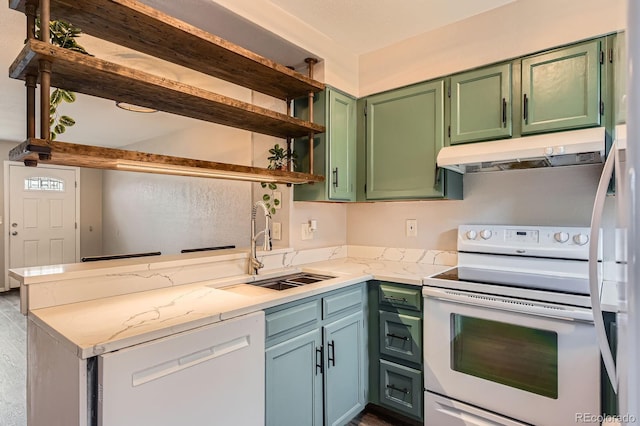 kitchen with a sink, green cabinets, a peninsula, under cabinet range hood, and white appliances