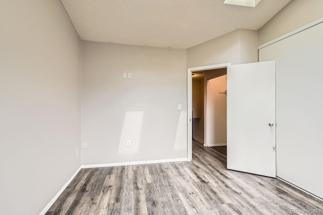 unfurnished room featuring baseboards and wood finished floors