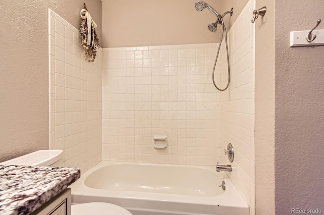 bathroom featuring toilet, a textured wall, and  shower combination