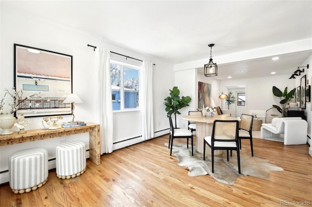 dining area featuring light hardwood / wood-style flooring and baseboard heating