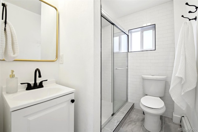 bathroom with tile patterned flooring, vanity, a baseboard heating unit, toilet, and a shower with door