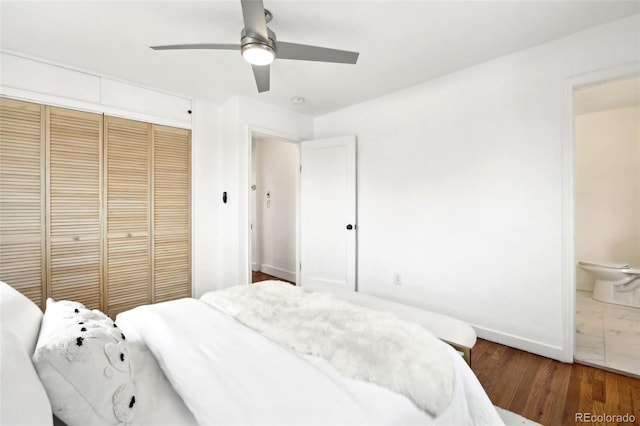 bedroom featuring connected bathroom, dark wood-type flooring, a closet, and ceiling fan