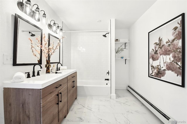 bathroom with tiled shower / bath, vanity, and a baseboard heating unit