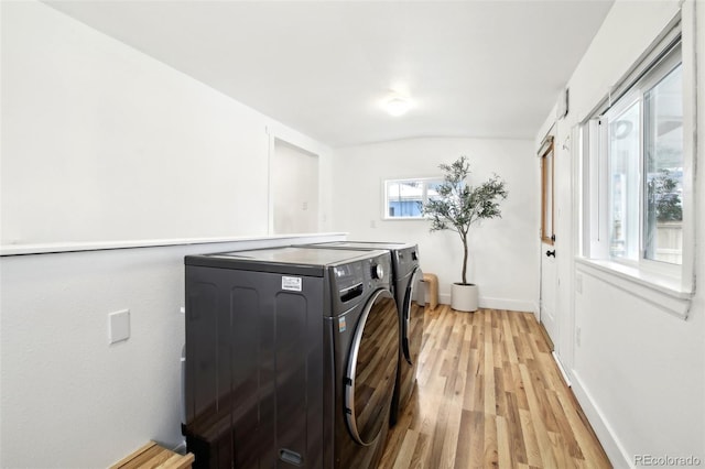 laundry area featuring independent washer and dryer and light wood-type flooring