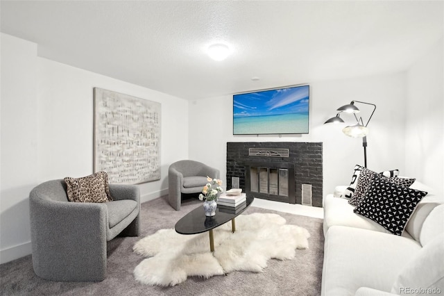 living room featuring carpet flooring, a textured ceiling, and a fireplace